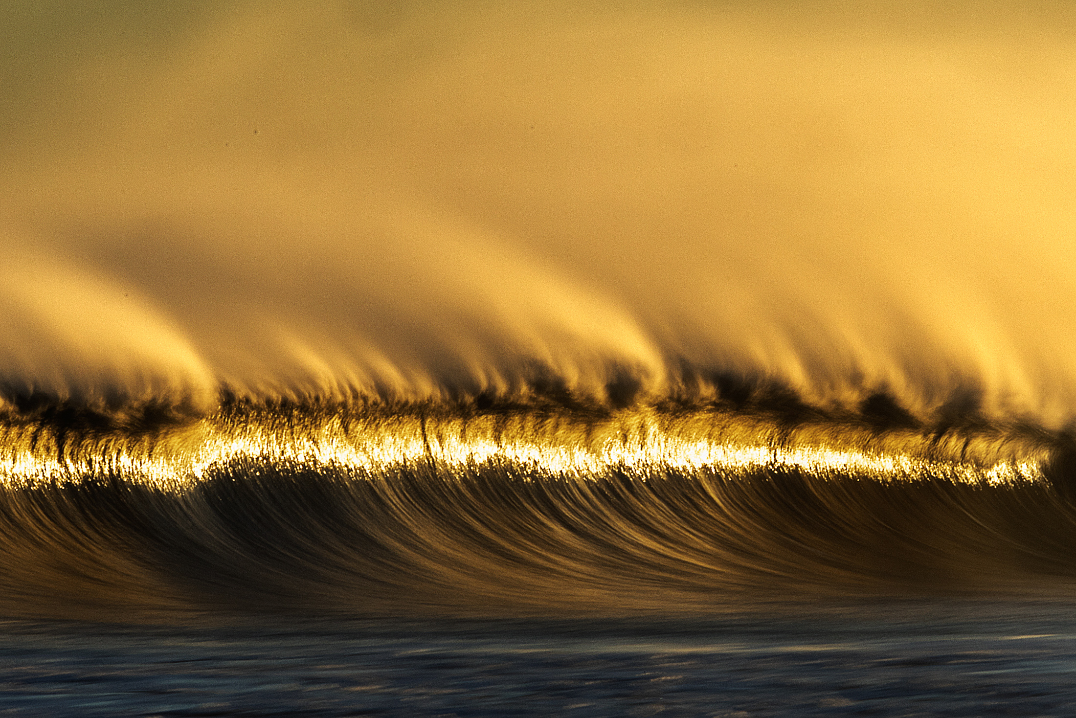 golden sunset wave by New Hampshire based commercial outdoor lifestyle photographer Brian Nevins