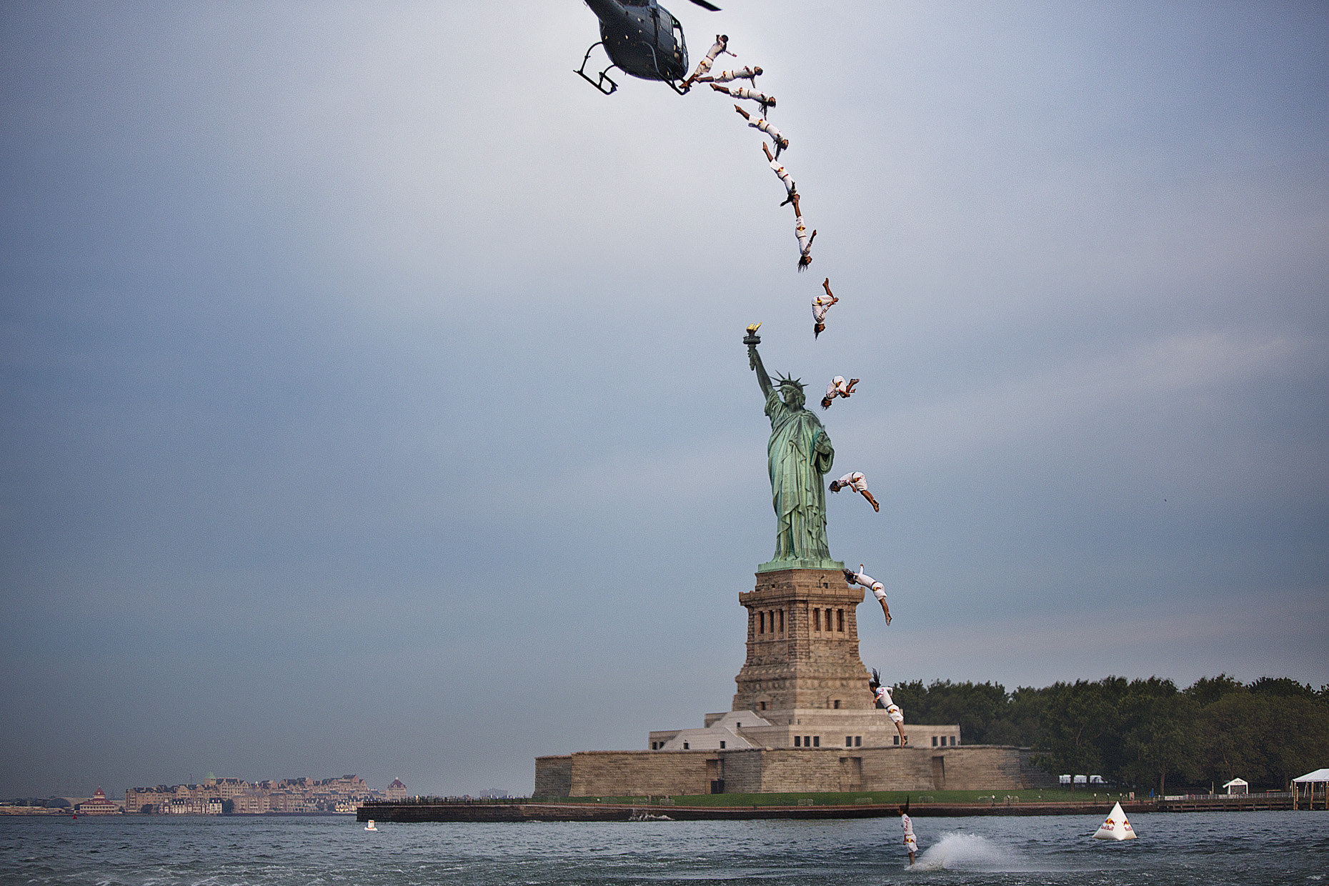 Orlando Duque cliff dives in front of the statue of Liberty in NYC for Red Bull by Boston based commercial sports photographer Brian Nevins